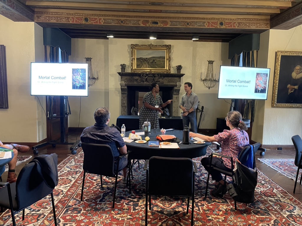 Members of the Metro West Writers Guild watching a presentation on the craft of writing at a local historic venue.